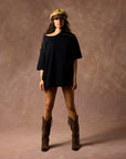 female modeling black boxy tee