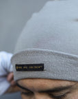 A man modeling the One Golden Thread OG Cloud Beanie in Shroom
