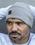 A man modeling the One Golden Thread OG Cloud Beanie in Shroom