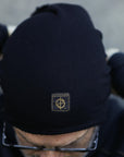 A man modeling the One Golden Thread OG Cloud Beanie in Black