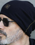 A man modeling the One Golden Thread OG Cloud Beanie in Black