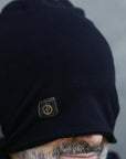 A man modeling the One Golden Thread OG Cloud Beanie in Black