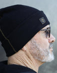 A man modeling the One Golden Thread OG Cloud Beanie in Black