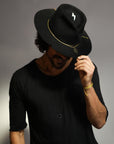 Male modeling bespoke hat and 108 talisman