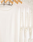 White crew neck three pack on wooden clothing racks