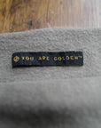 The One Golden Thread OG Cloud Beanie in Shroom with the saying "You are golden"