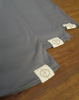 Flat lay of ultimate tee three pack in deep clay