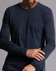 Man modeling a long sleeve crew shirt in charcoal blue