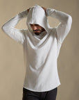 Man modeling white long-sleeve hooded tee