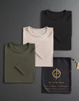 three folded shirts in different colors on a dark gray background
