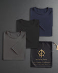 three folded shirts in different colors on a dark gray background