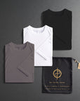 three folded shirts in different colors on a dark gray background