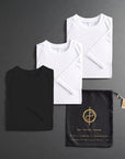 three folded shirts in different colors on a dark gray background