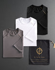 three folded shirts in different colors on a dark gray background