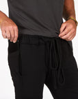 Male modeling black yogo mid shorts