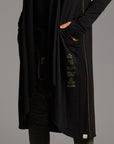 Man modeling a duster with gold graphics