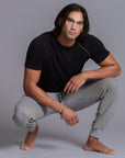 A man modeling Deep Clay gray colored jogger pants
