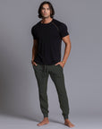 A man modeling Urban Forest green colored jogger pants