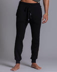 A man modeling black colored jogger pants