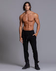 A man modeling black colored jogger pants