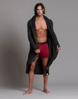 A man modeling the One Golden Thread Unders in Wine Red