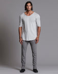 Man modeling the milano pant in deep clay gray