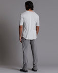 Man modeling the milano pant in deep clay gray