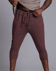 Male modeling yogo mid pants in brazen