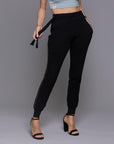 A woman modeling the One Golden Thread Jogga Pants in Black
