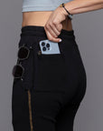 A woman modeling the One Golden Thread Jogga Pants in Black
