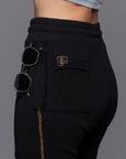 A woman modeling the One Golden Thread Jogga Pants in Black