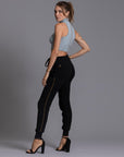 A woman modeling the One Golden Thread Jogga Pants in Black
