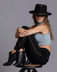 A woman modeling the One Golden Thread Jogga Pants in Black
