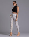 A woman modeling the One Golden Thread Jogga Pants in White Stone