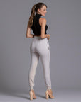 A woman modeling the One Golden Thread Jogga Pants in White Stone