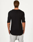 Male modeling black crew neck shirt