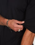 Male modeling black crew neck shirt