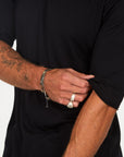 Male modeling black crew neck shirt
