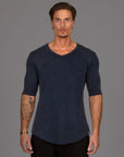 A man wearing the One Golden Thread Fleece Sweater v neck shirt in the blue mineral color