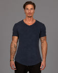 A man wearing the One Golden Thread Fleece Sweater v neck shirt in the blue mineral color
