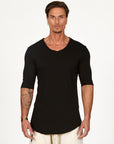 Man modeling a mid sleeve V Neck shirt in black