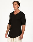 Man modeling a mid sleeve shirt in black