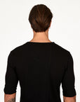 Man modeling a mid sleeve shirt in black