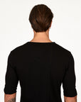Male modeling black v neck shirt