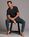 man modeling pants in mineral blue