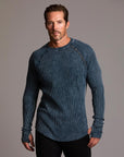 A man modeling a One Golden Thread Waffle Long Sleeve Raglan shirt in blue mineral