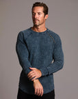 A man modeling a One Golden Thread Waffle Long Sleeve Raglan shirt in blue mineral