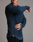 A man modeling a One Golden Thread Waffle Long Sleeve Raglan shirt in blue mineral