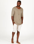 A man modeling white stone milanos mid shorts