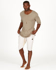A man modeling white stone milanos mid shorts